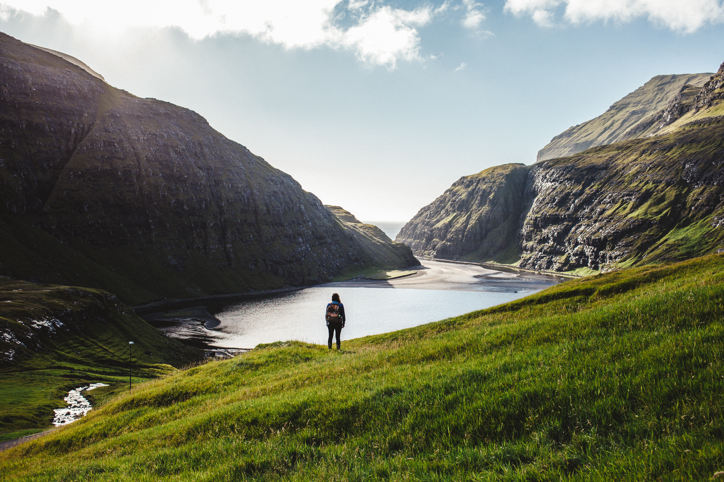 Hiker enjoys the breathtaking landscapes, Faroe Islands