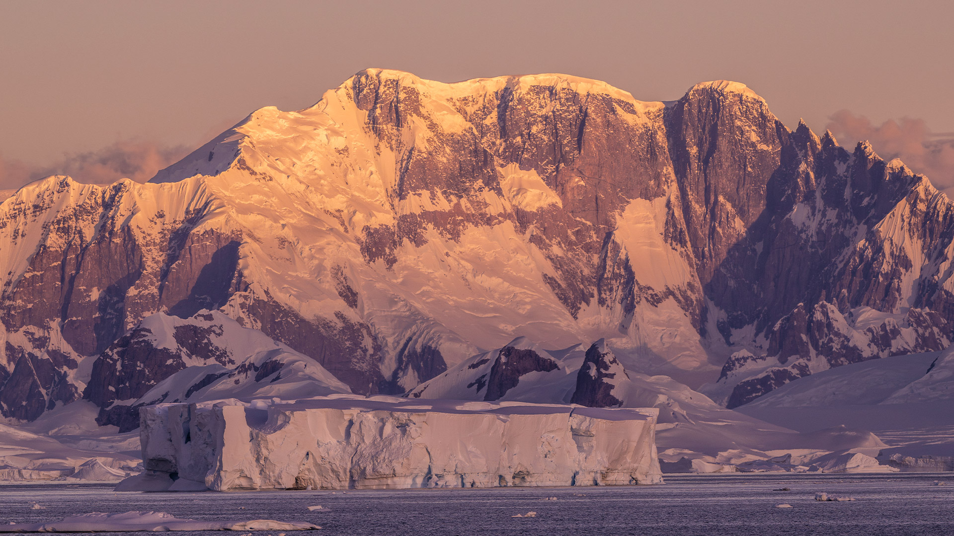Antarctic mountains glowing at dusk