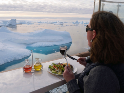 Passenger enjoying meal onboard the Greg Mortimer, Antarctica; Scott Portelli
